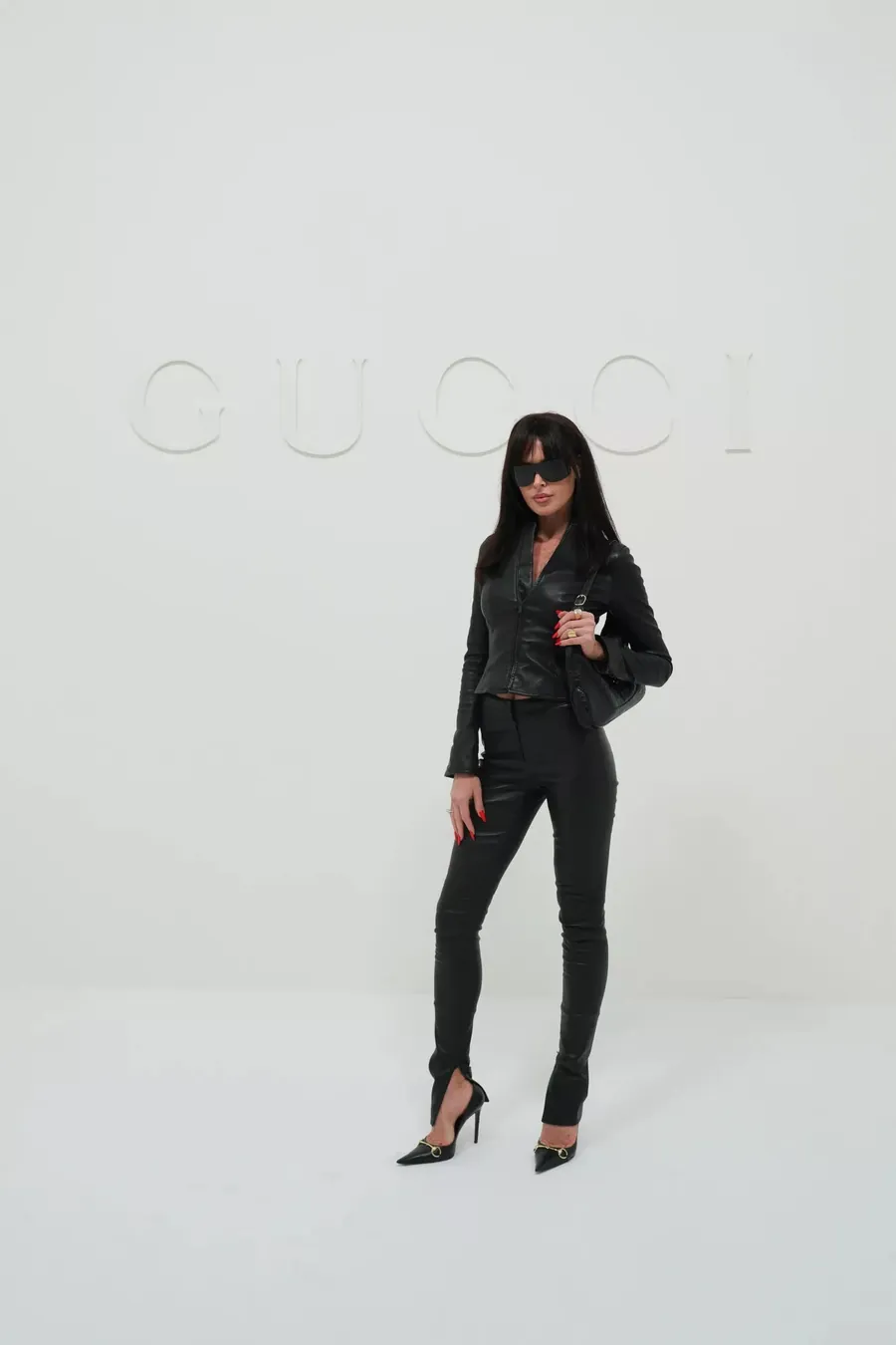 Gucci The Store Show: woman dressed head to toe in black leather with a black shoulder bag