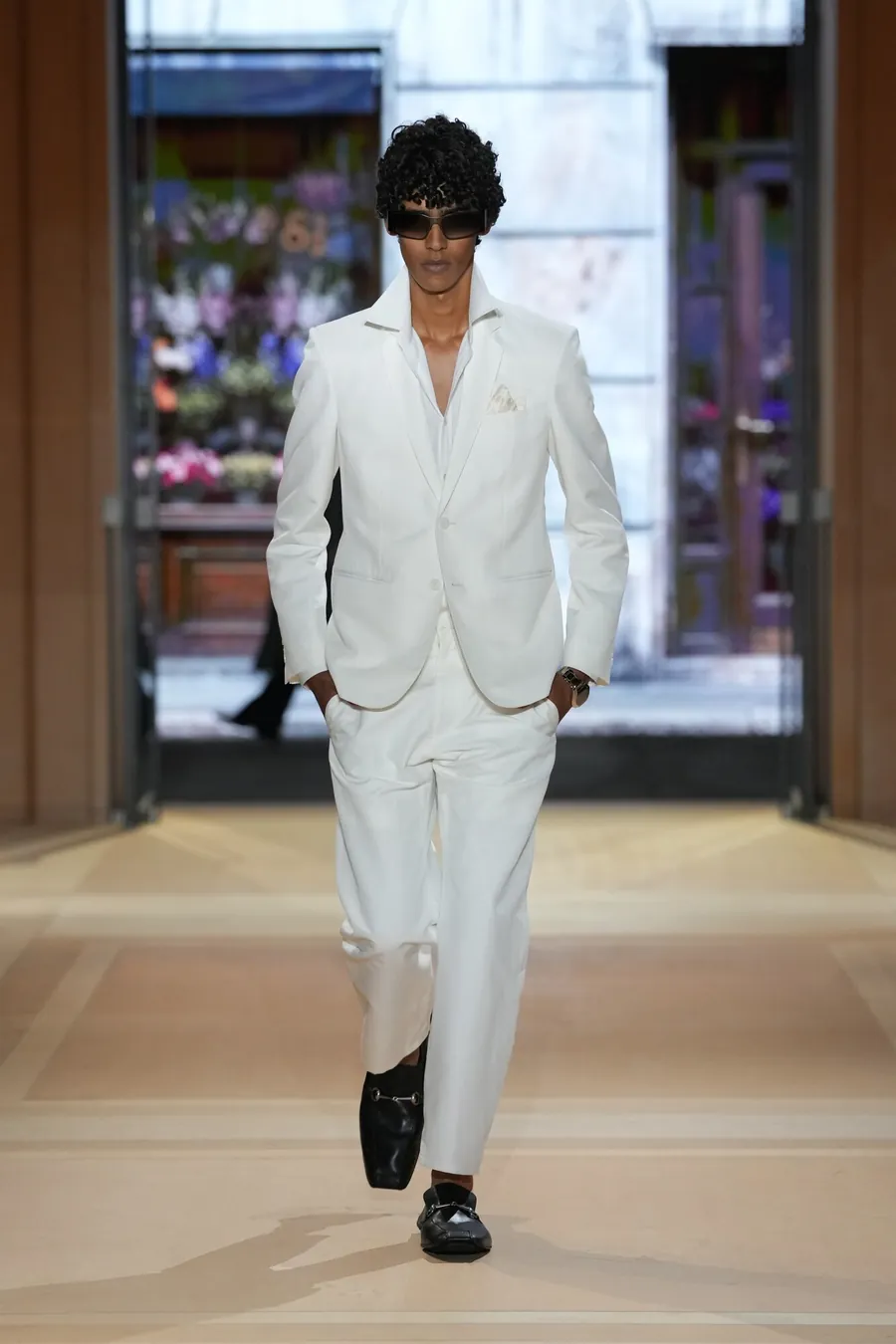 Gucci The Store Show: model in a white suit and black loafers on the runway